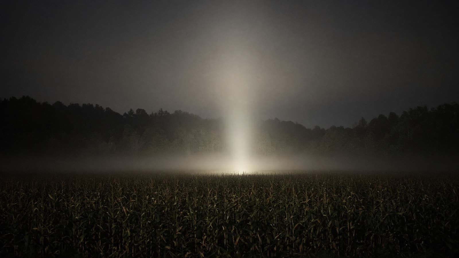 AI still: a column of light over open ground
