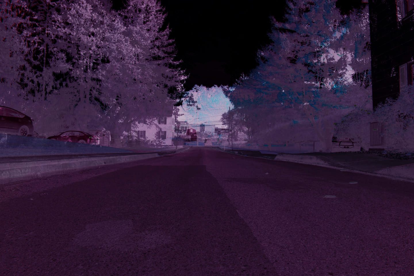 Infrared Block — Lancaster County. Trees blooming white under a black sky. A parked car. The county in a spectrum the eye doesn’t get for free.