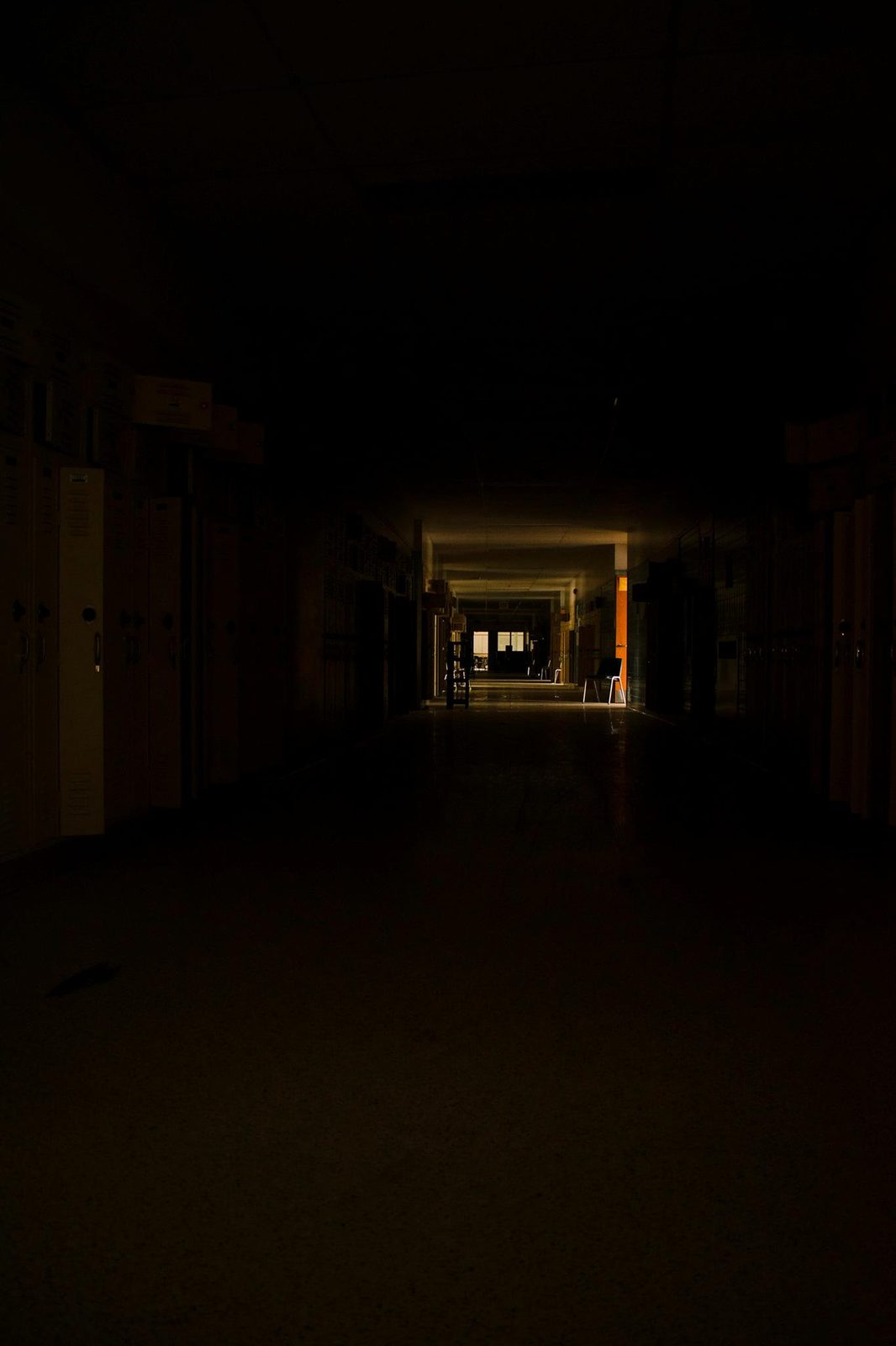Lockers After Dark — Lancaster County. A school hallway with the lights mostly dead. Lockers on both walls, one door of daylight at the end. You already know this sound.