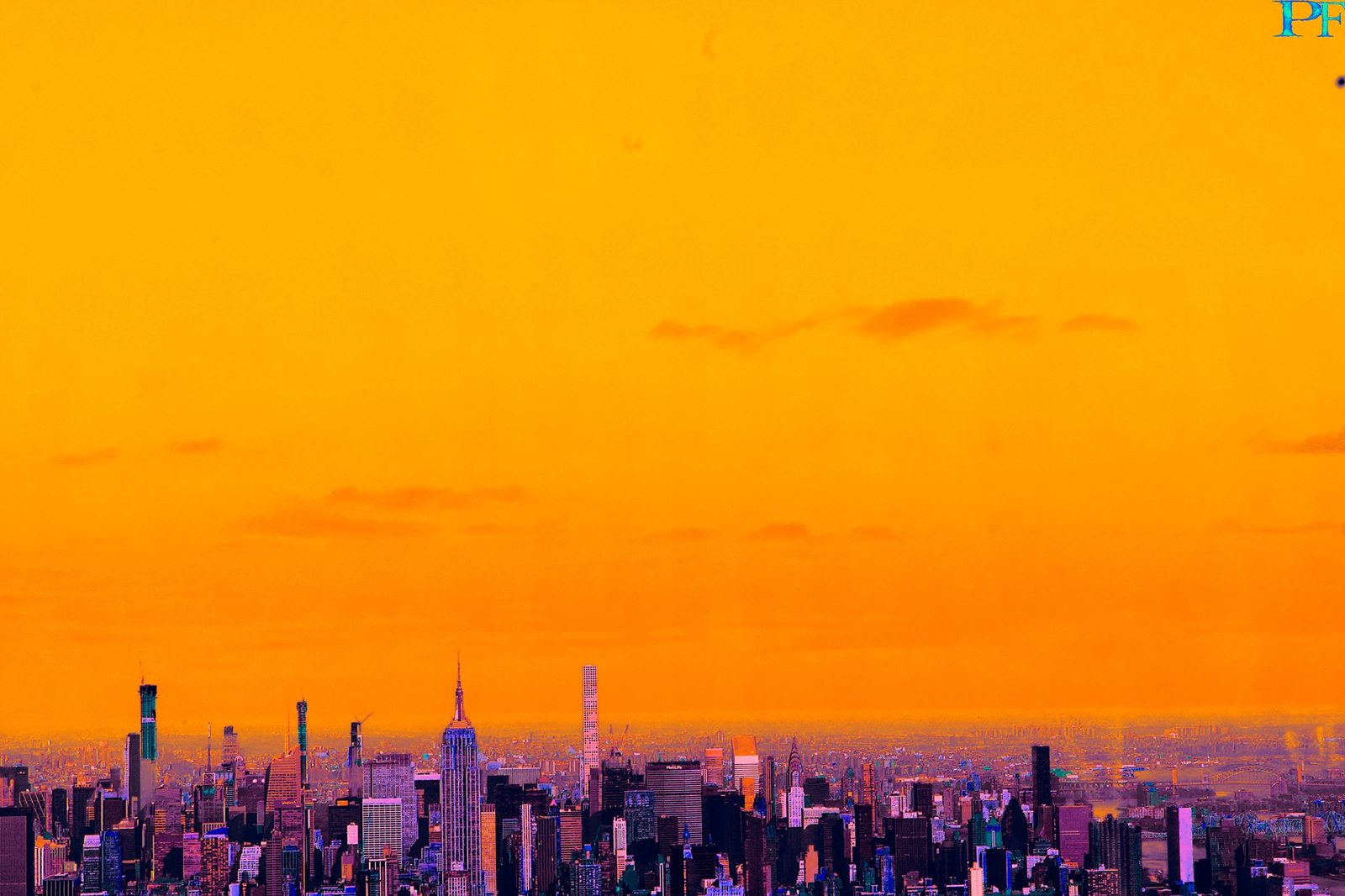 Orange Hour, New York — New York. The island under a sky the color of warning. Skyline as a thin dark saw. PF in the corner, small on purpose.