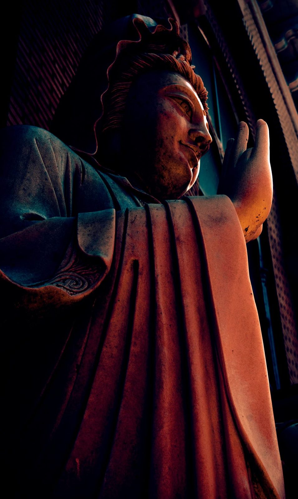The Gesture — Lancaster County. A statue looking up, one hand raised. Shot from below so the robe is the landscape. Stone with a posture.